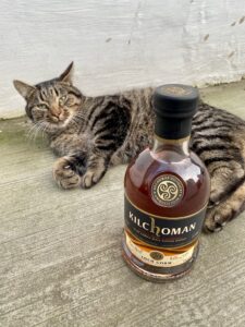 Bottle of Kilchoman whisky with a cat