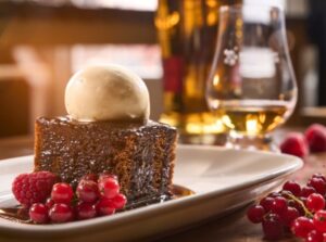 Sticky toffee pudding, berries and ice cream with a dram.
