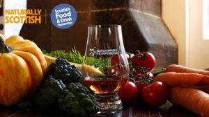 A dram of Scotch whisky pictured next to raw food ingredients