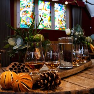 A flight of whiskies pictured in the Castlehill room with festive décor.